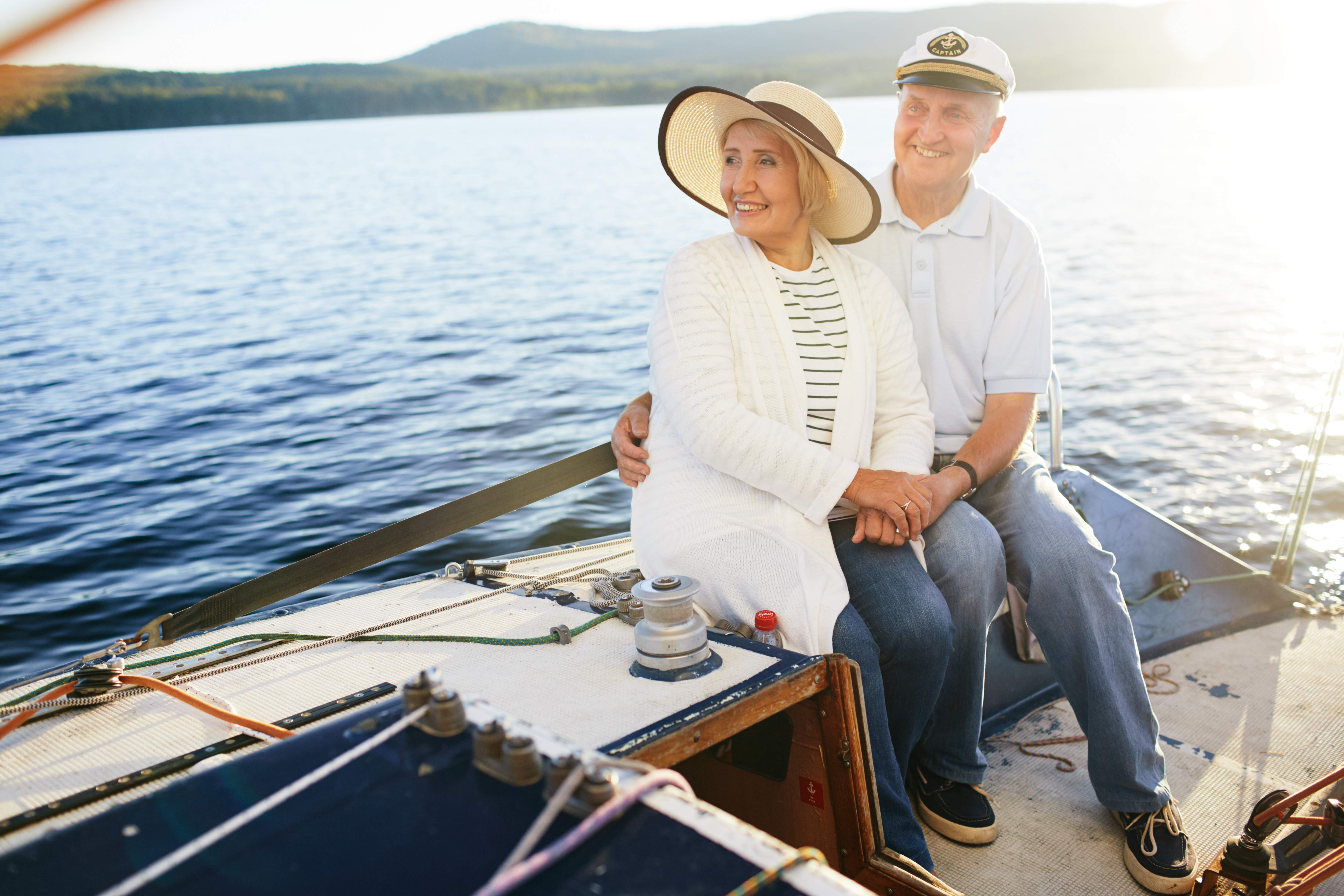 Older couple sitting on a sail boat.