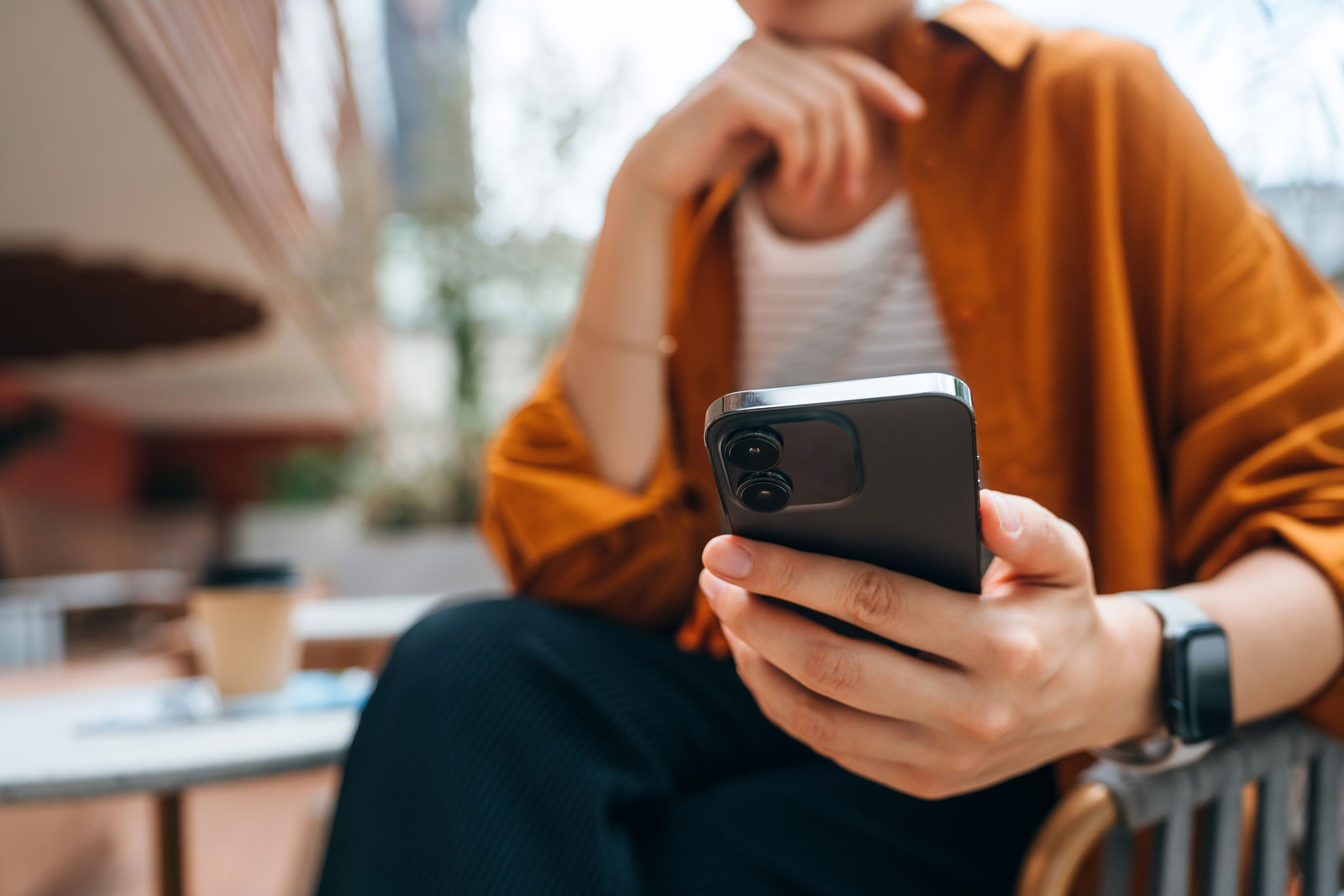 Person viewing financial information on a smartphone using the Manulife Wealth app