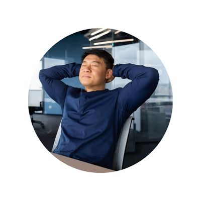 middle aged asian man lean back on an office share with his eyes closed and hands wrapped behind his head