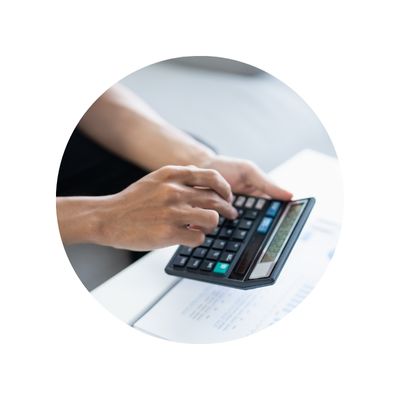 A hand typing into a calculator