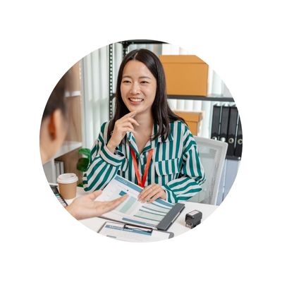 Young asian accountant smiling behind a desk