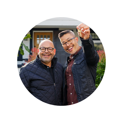 Middle aged gay couple with keys to new home