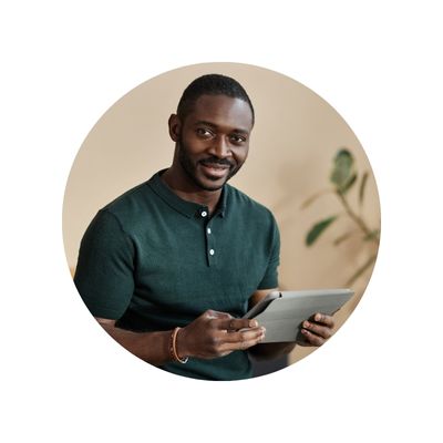handsome african-american man smiling and holding a tablet