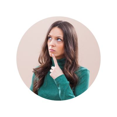 Young woman in green turtleneck pointing at chin, thinking